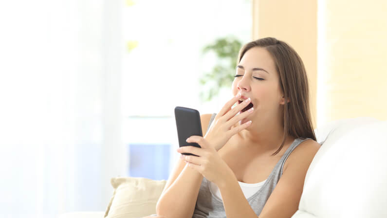 woman bored reading online