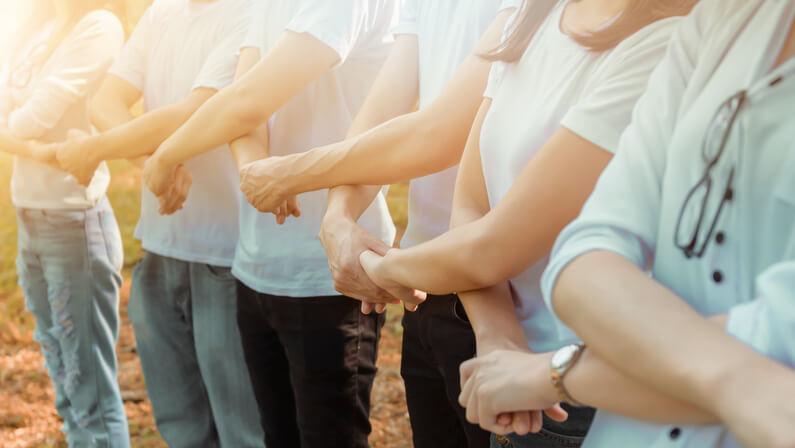 people joining hands in celebrating corporate social responsibility